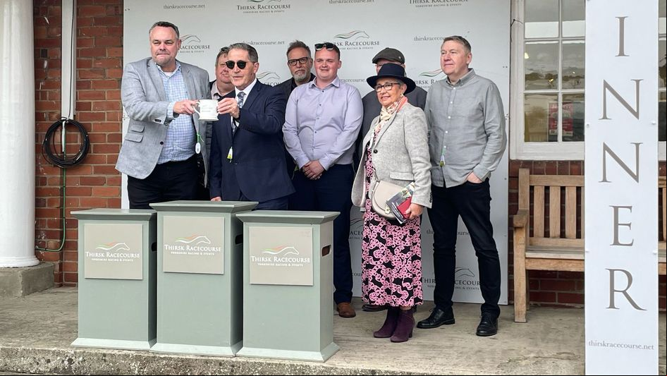 of the Sporting Life Racing Club receive the winning trophy
