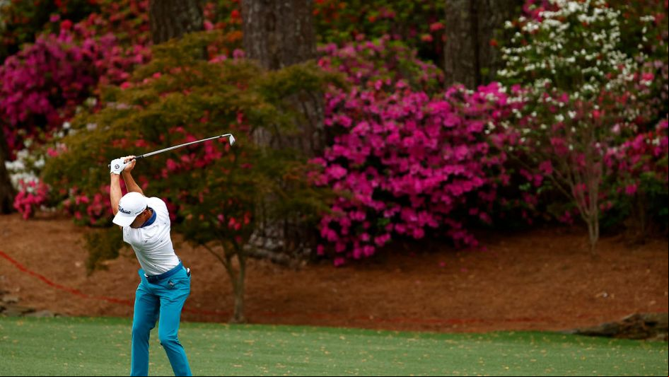 Justin Thomas hits an approach to the 13th hole