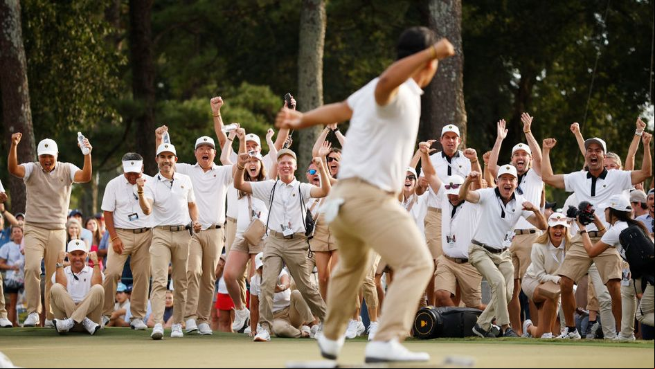 Tom Kim celebrates after collecting a Presidents Cup point
