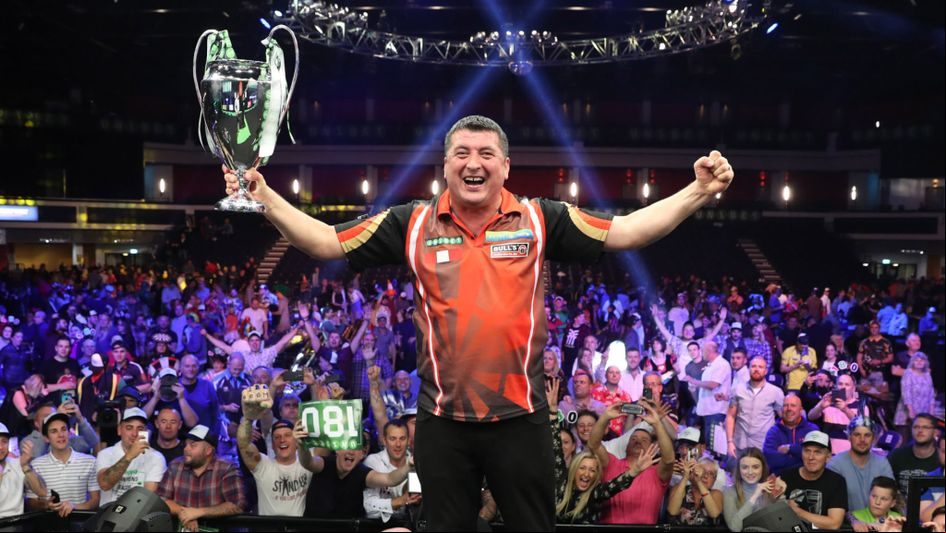 Mensur Suljovic with the Champions League of Darts trophy (Lawrence Lustig, PDC)